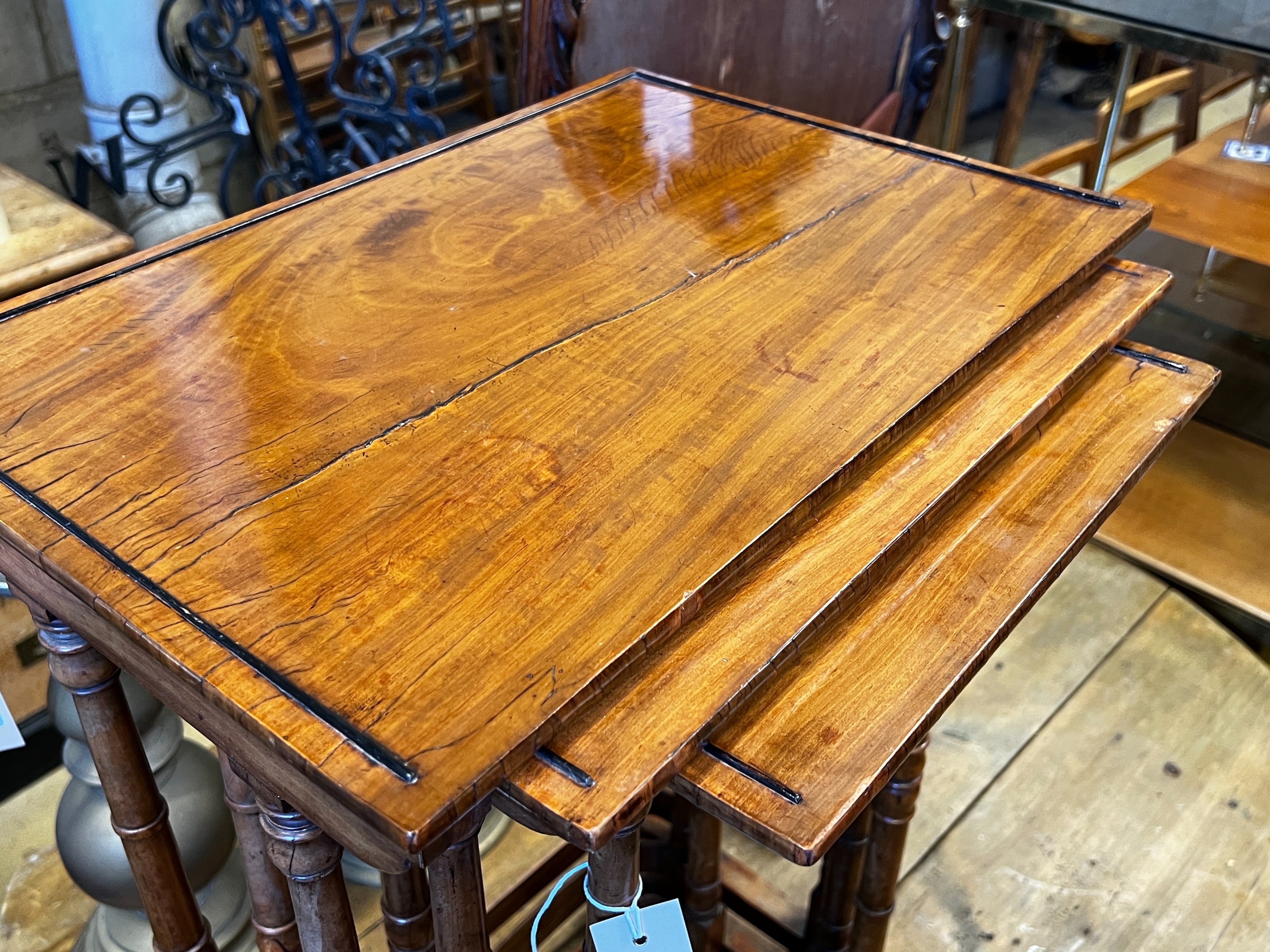 A nest of three William IV rectangular satinwood and mahogany tea tables, width 48cm, depth 33cm, height 73cm